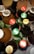 A collection of various bottled beverages placed on ice, featuring brands like Coca-Cola, Sprite, and Stewart’s. The bottles display vibrant caps with brand logos.