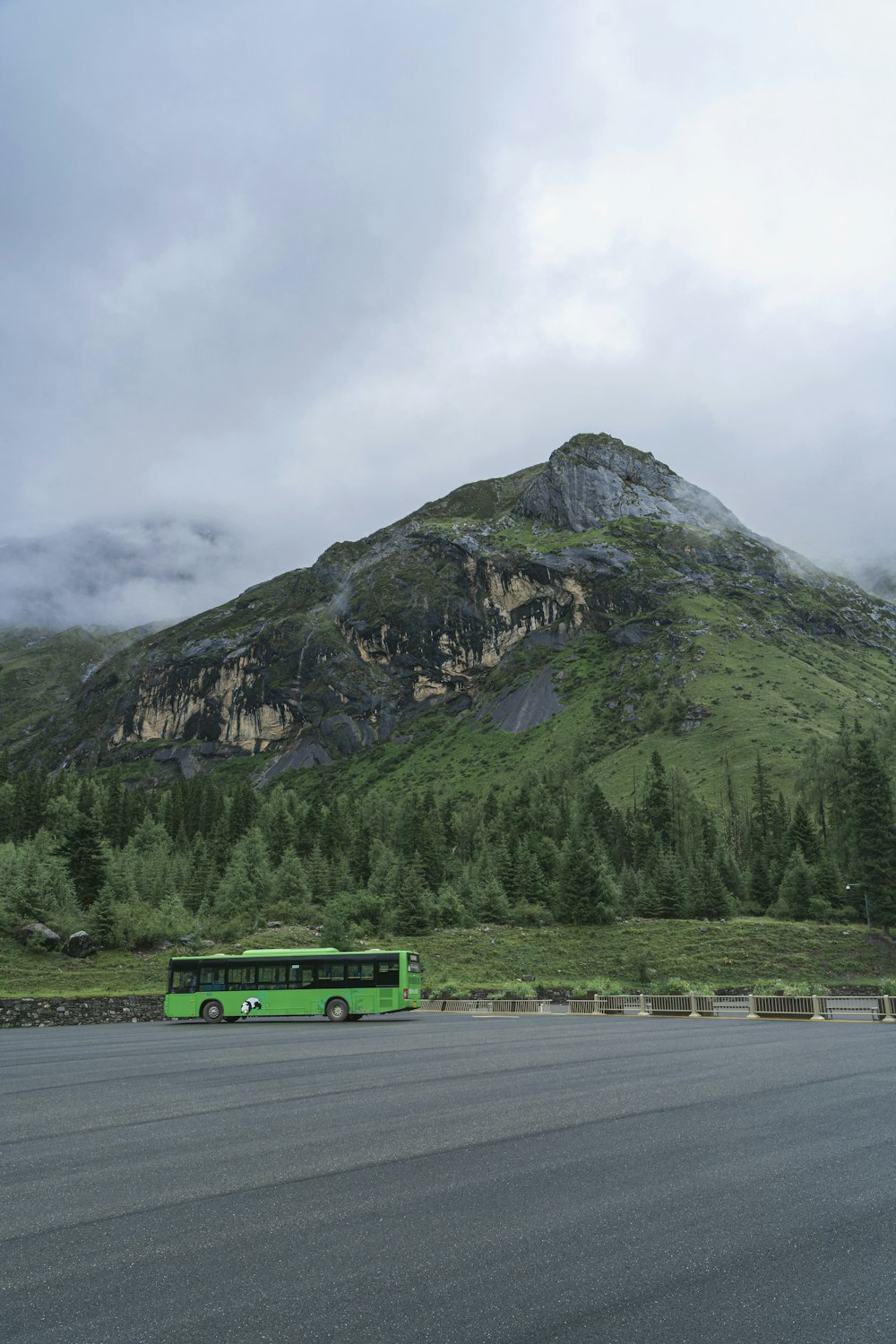 green truck on road near mountain during daytime