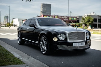 black mercedes benz coupe on road during daytime