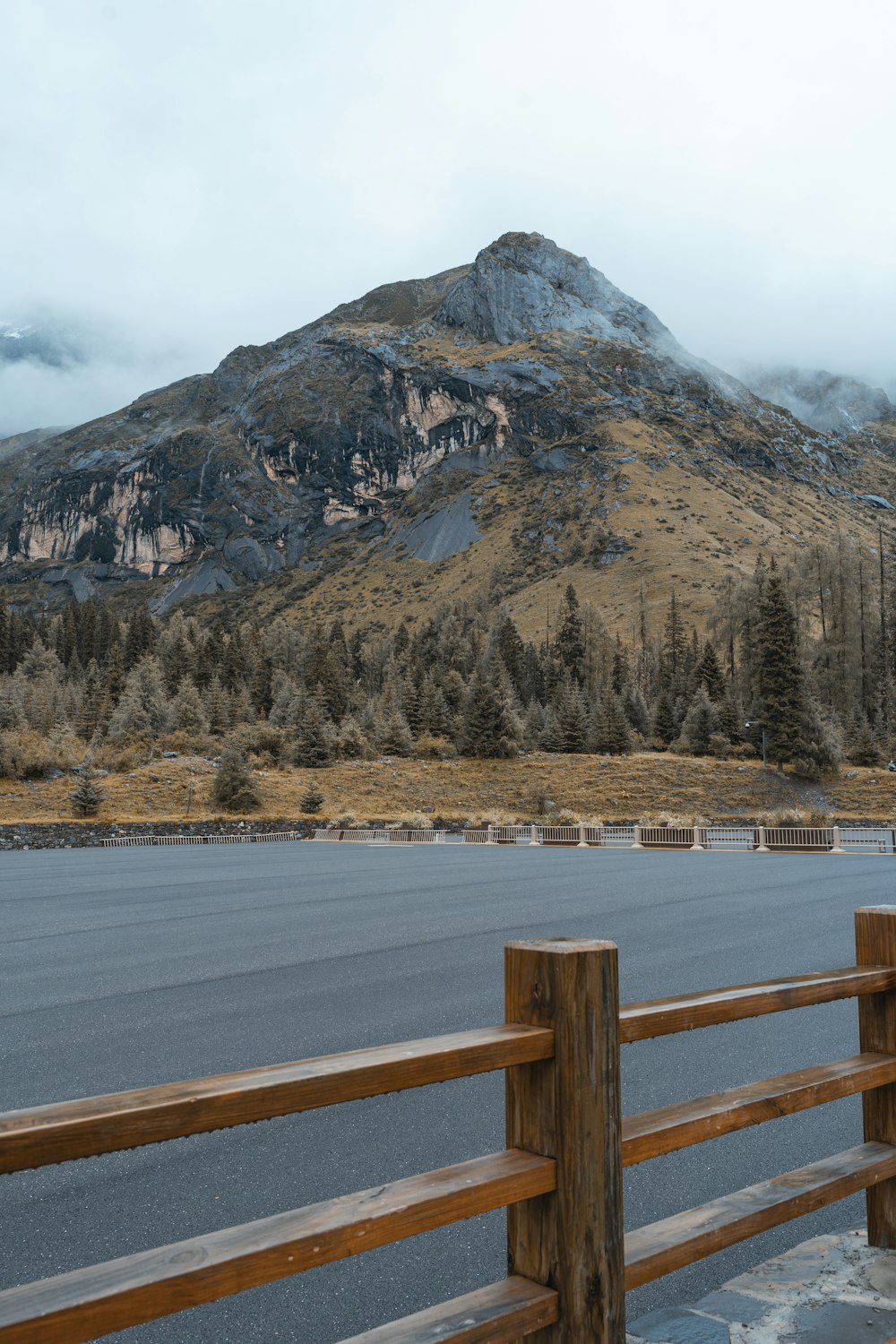 brown wooden fence near brown mountain during daytime