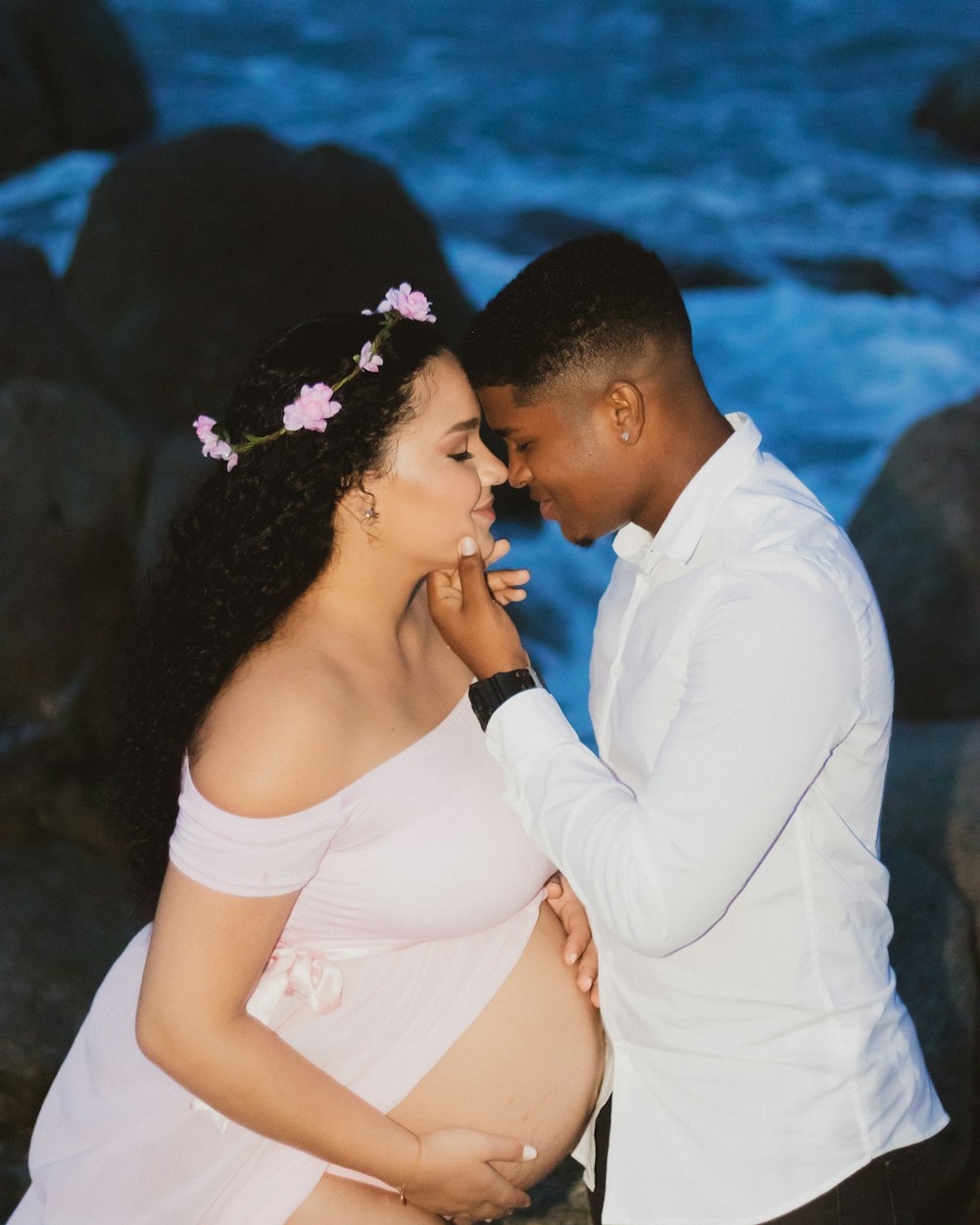 man kissing womans forehead