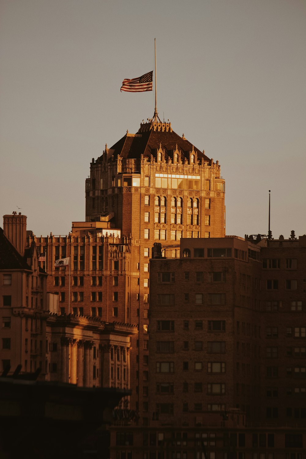 brown concrete building with flag of us a during daytime