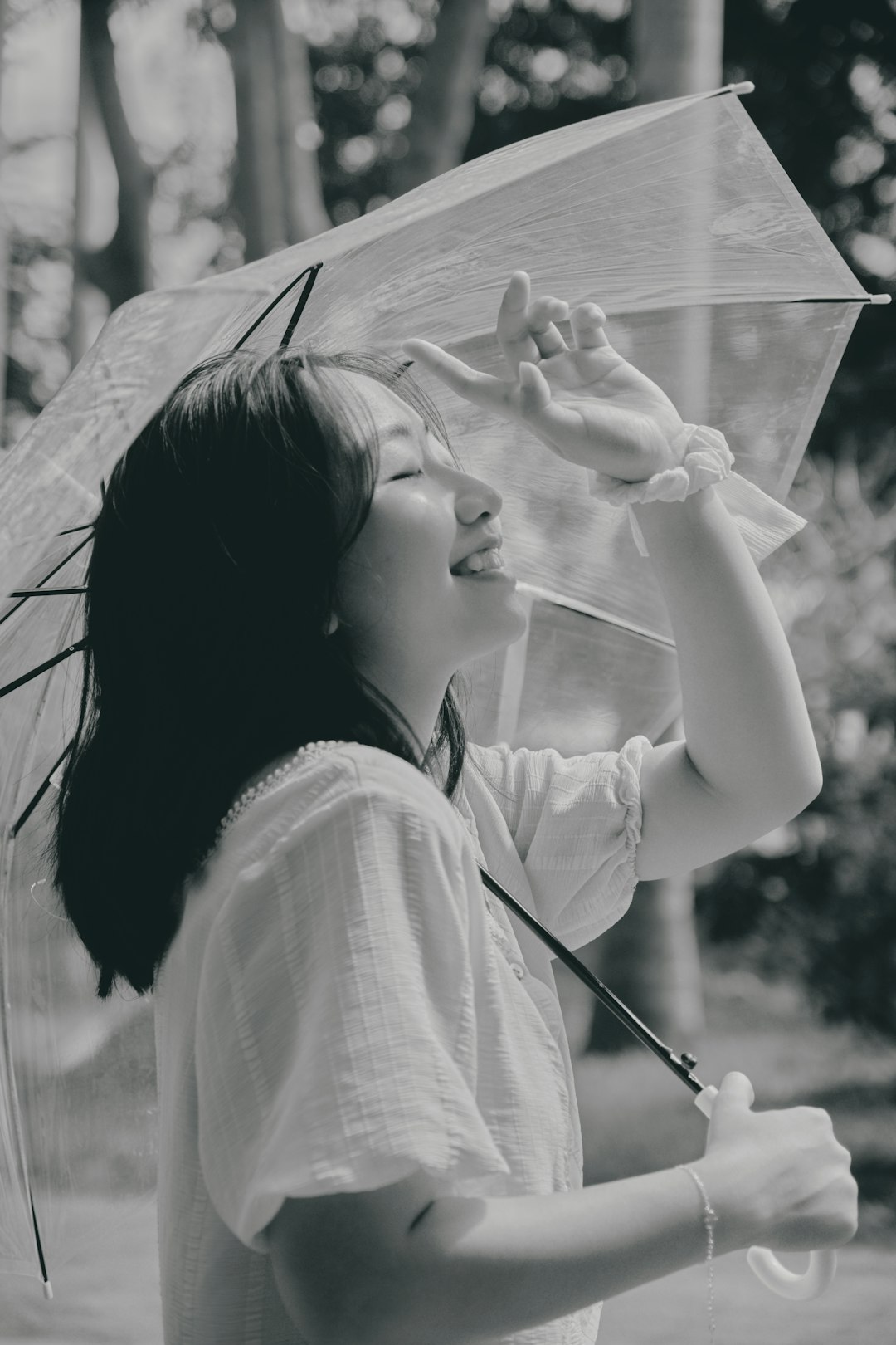 woman in white shirt holding umbrella