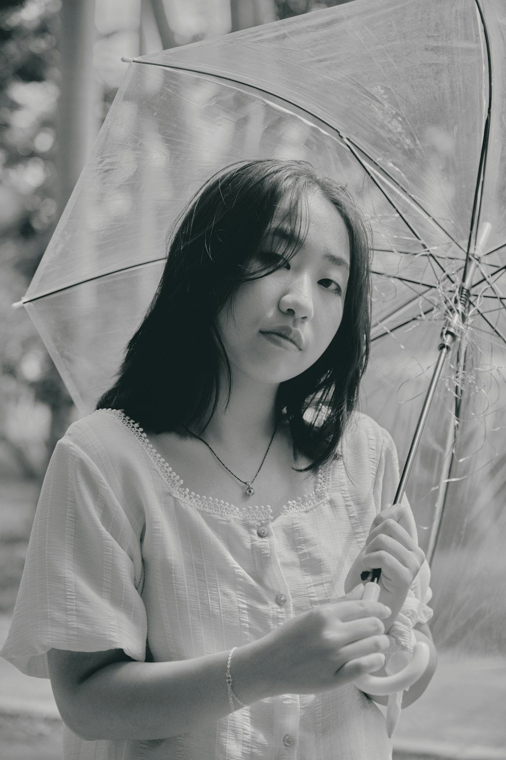 girl in white long sleeve shirt holding umbrella