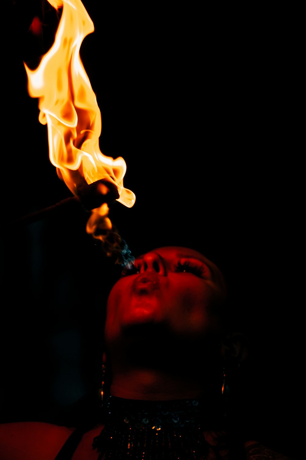 Mann raucht mit Feuer im Mund