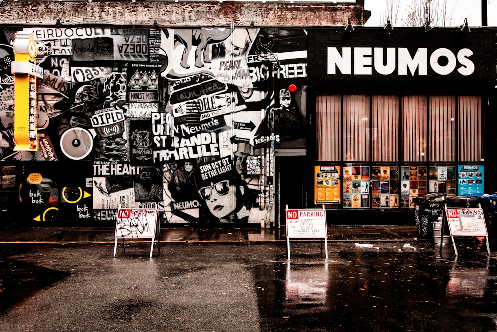 man in black jacket standing in front of store