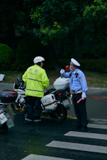 2 men in green jacket riding motorcycle during daytime