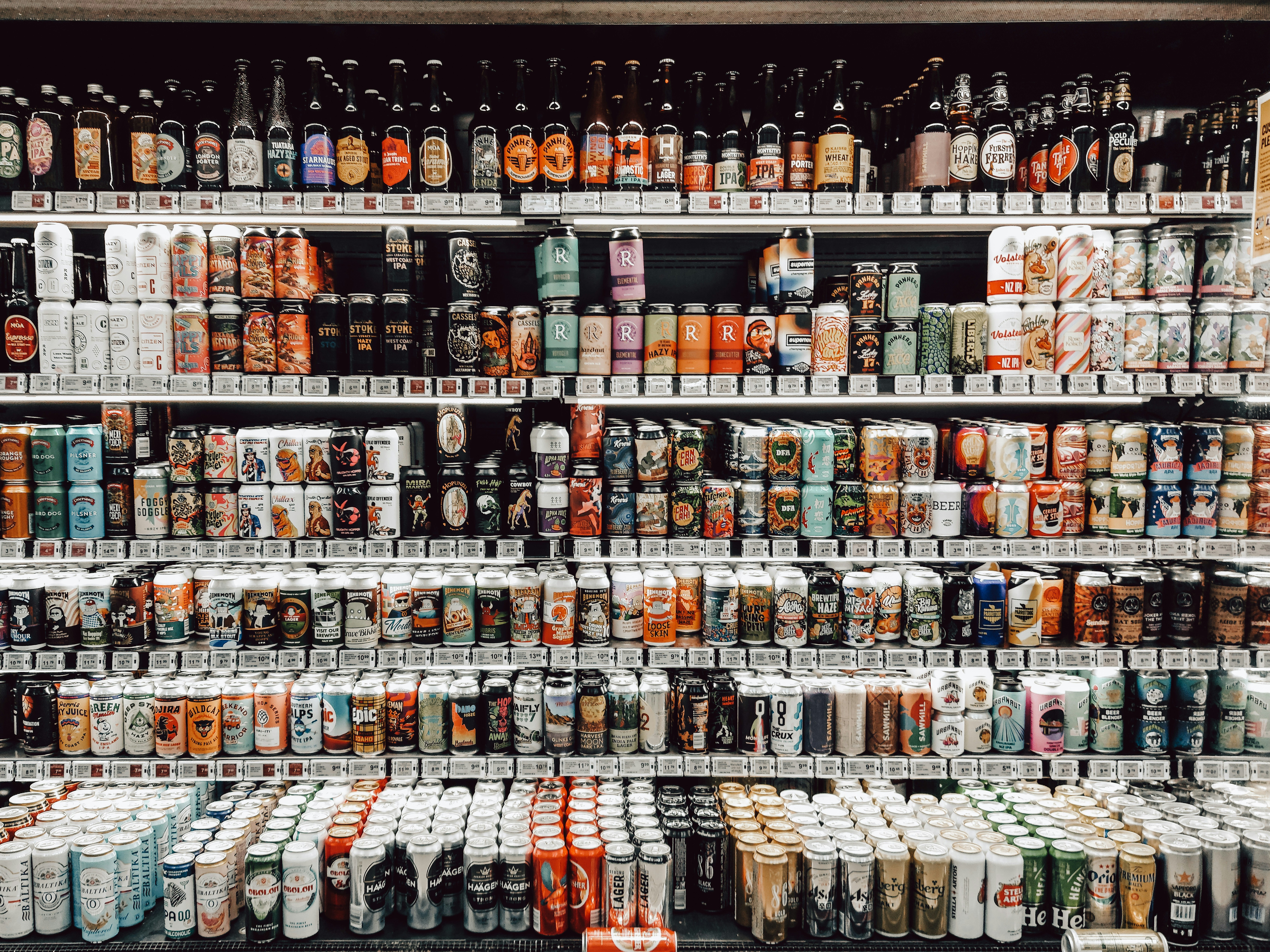 assorted bottles on brown wooden shelf