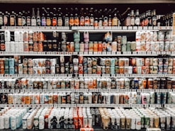 assorted bottles on brown wooden shelf