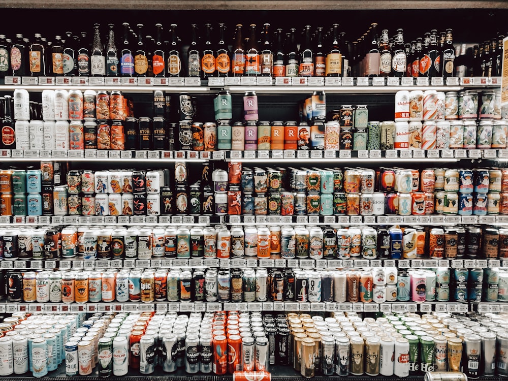 assorted bottles on brown wooden shelf