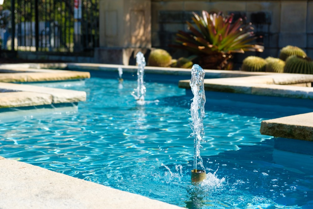 water fountain in the middle of the pool