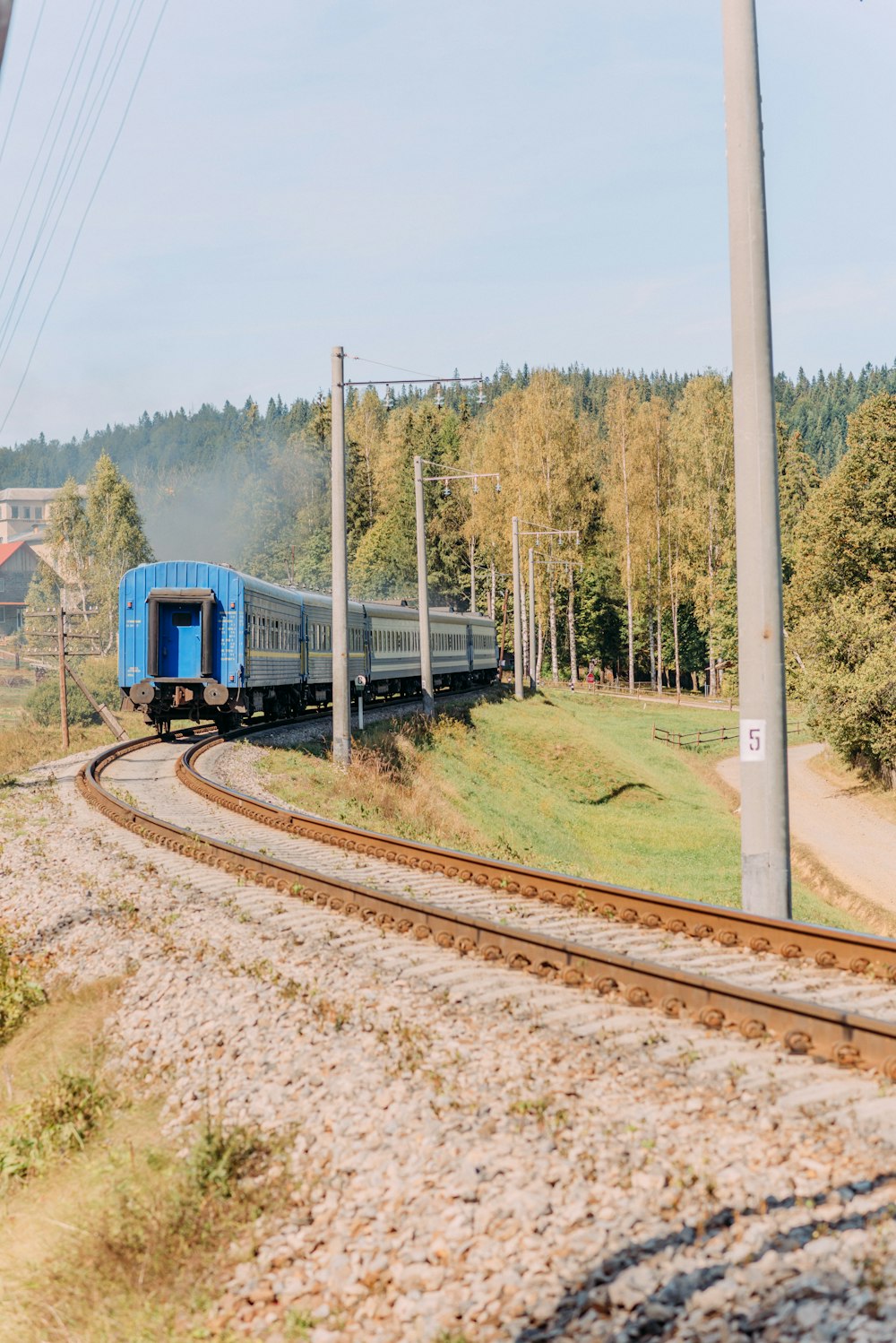 blue train on rail tracks during daytime