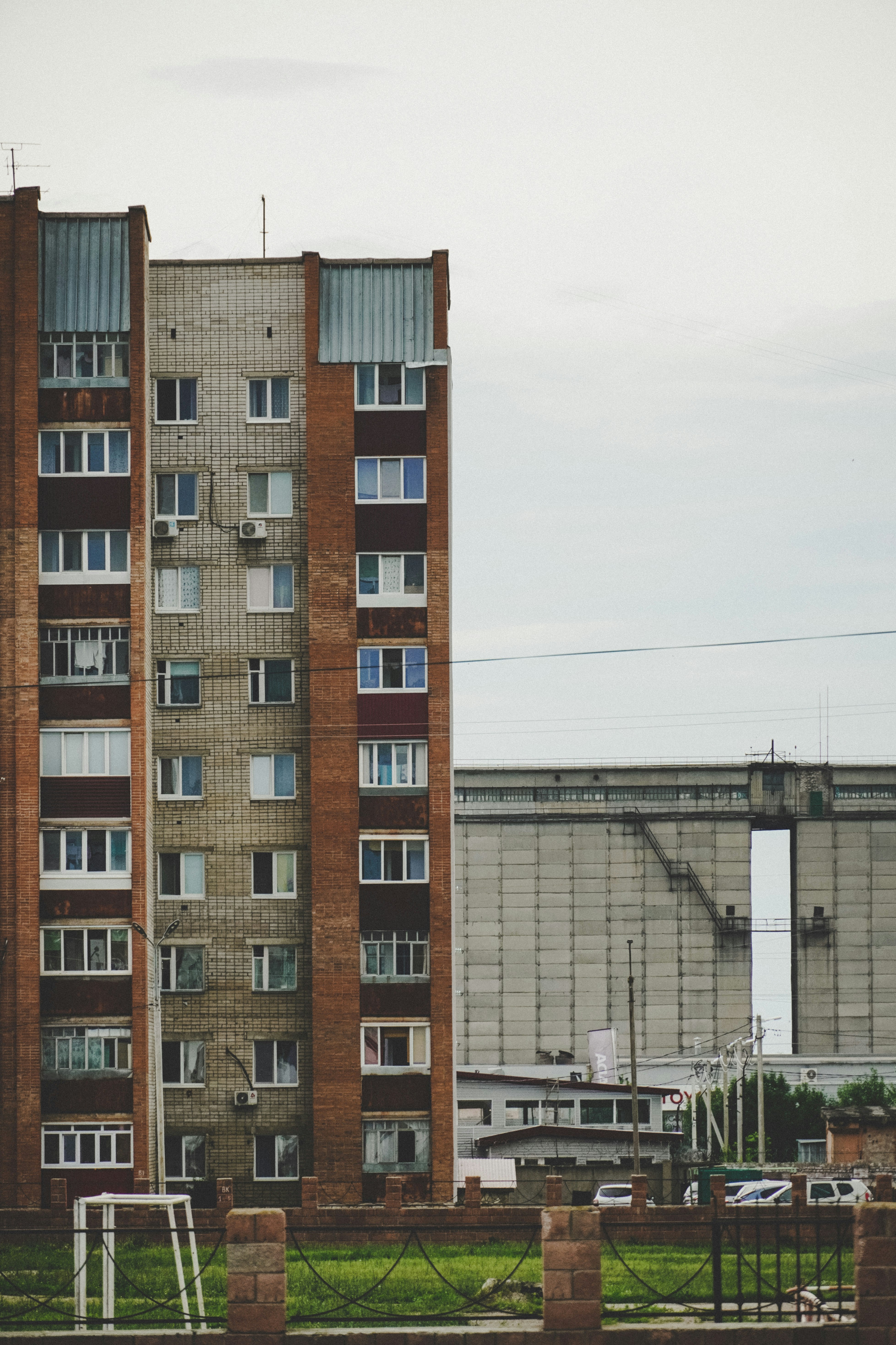 brown and white concrete building under white sky during daytime