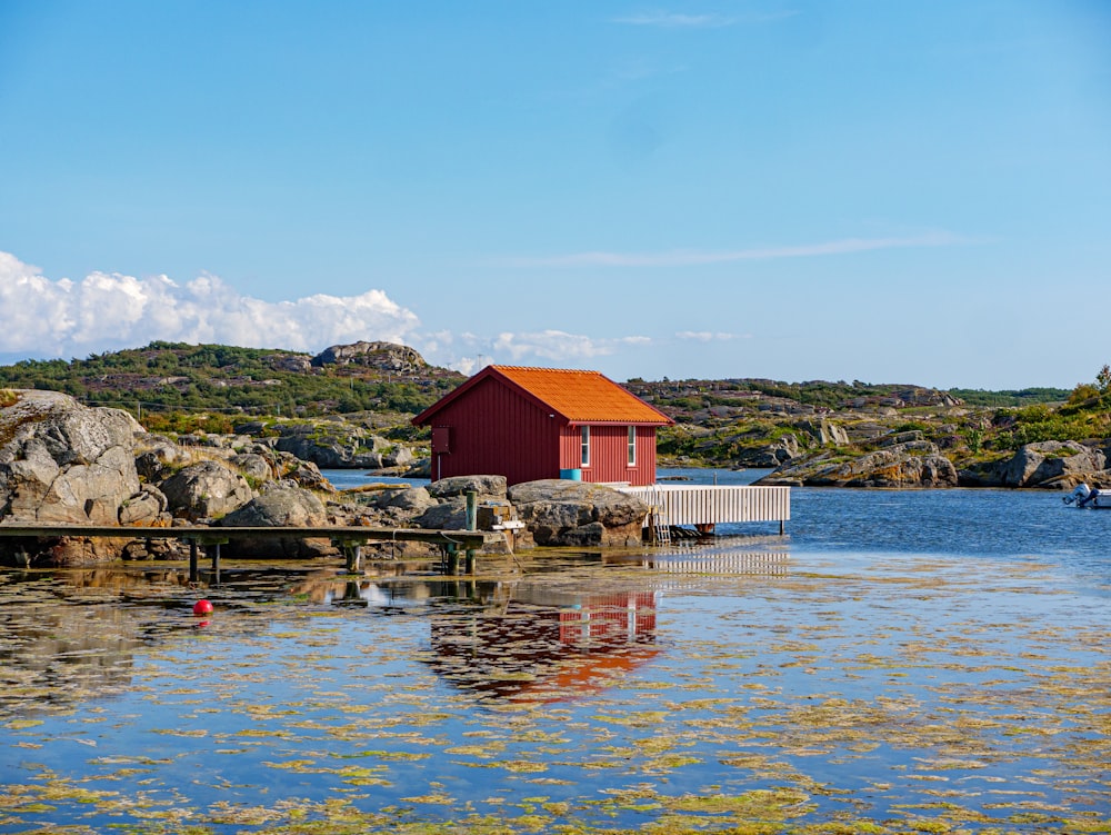 brown wooden house on body of water during daytime