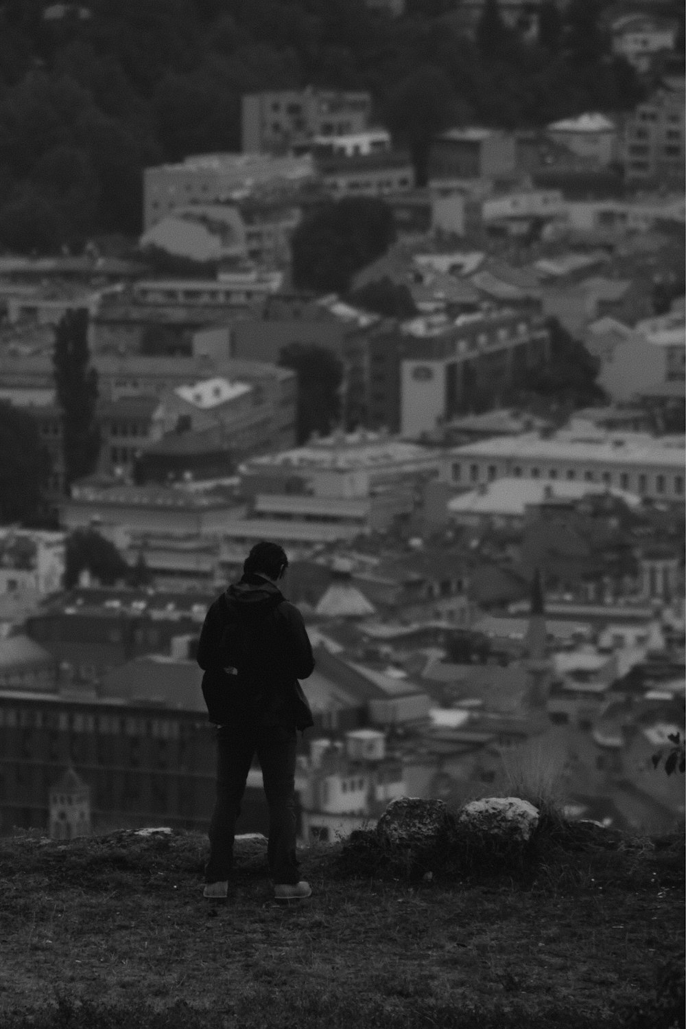 man in black jacket standing on top of building during daytime