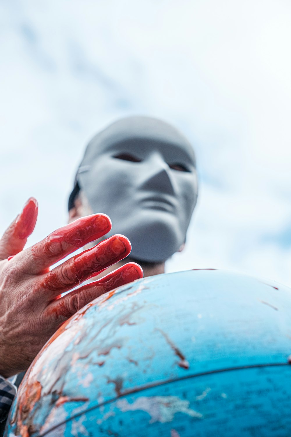 person holding blue and white globe