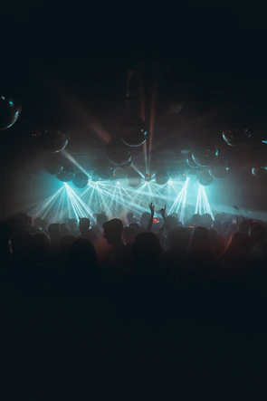 Guests enjoying a lively dance floor illuminated by electric blue and marine blue lights.