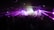 A vibrant nightclub scene with a crowd of people dancing under multicolored laser lights. Numerous disco balls hang from the ceiling, reflecting the illumination, creating a lively and energetic atmosphere.