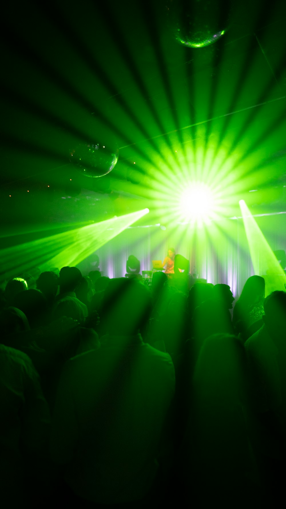 a group of people sitting in front of a green light