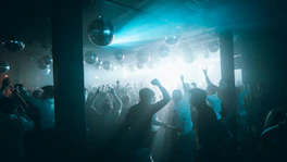 people standing on stage with lights