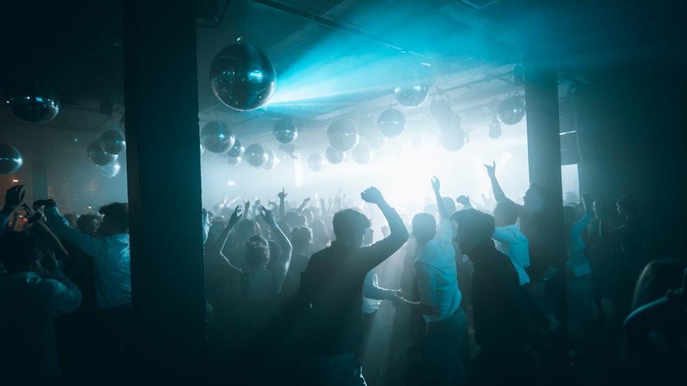 people standing on stage with lights