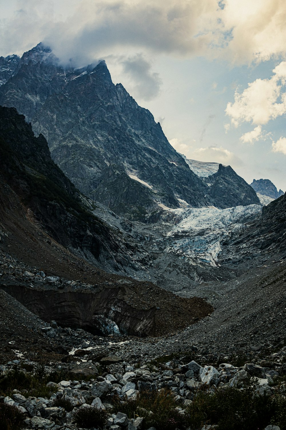 gray rocky mountain under white cloudy sky during daytime