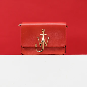 A bold red bag with sharp eyes glaring, symbolizing defiance against corporate greed.