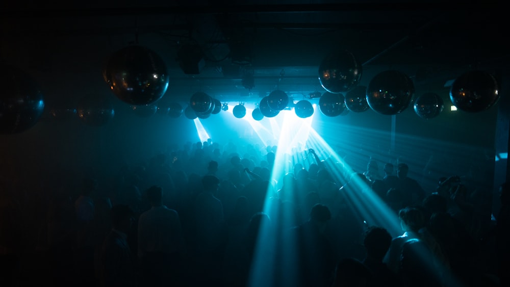 people standing on stage with blue lights