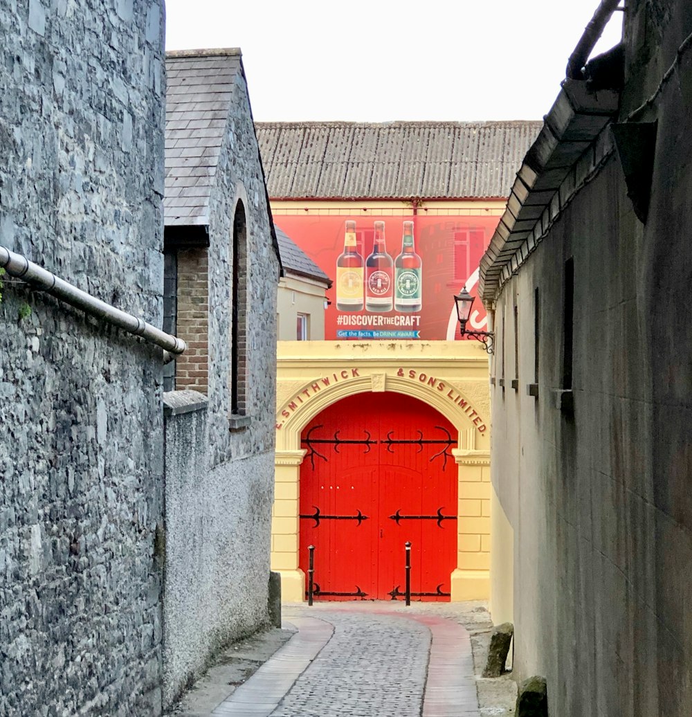 red wooden door on gray concrete building