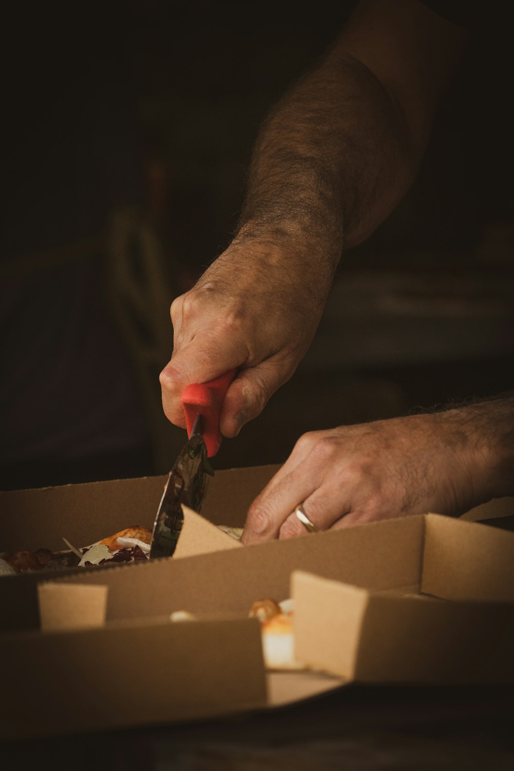 person holding brown wooden chopping board