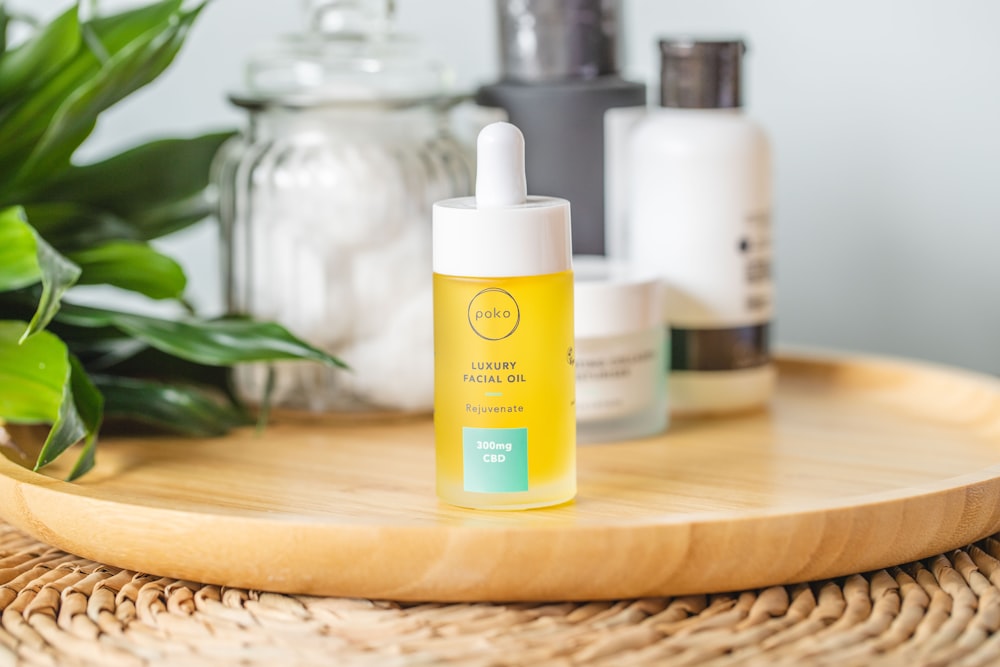 white and yellow plastic bottle on brown wooden table