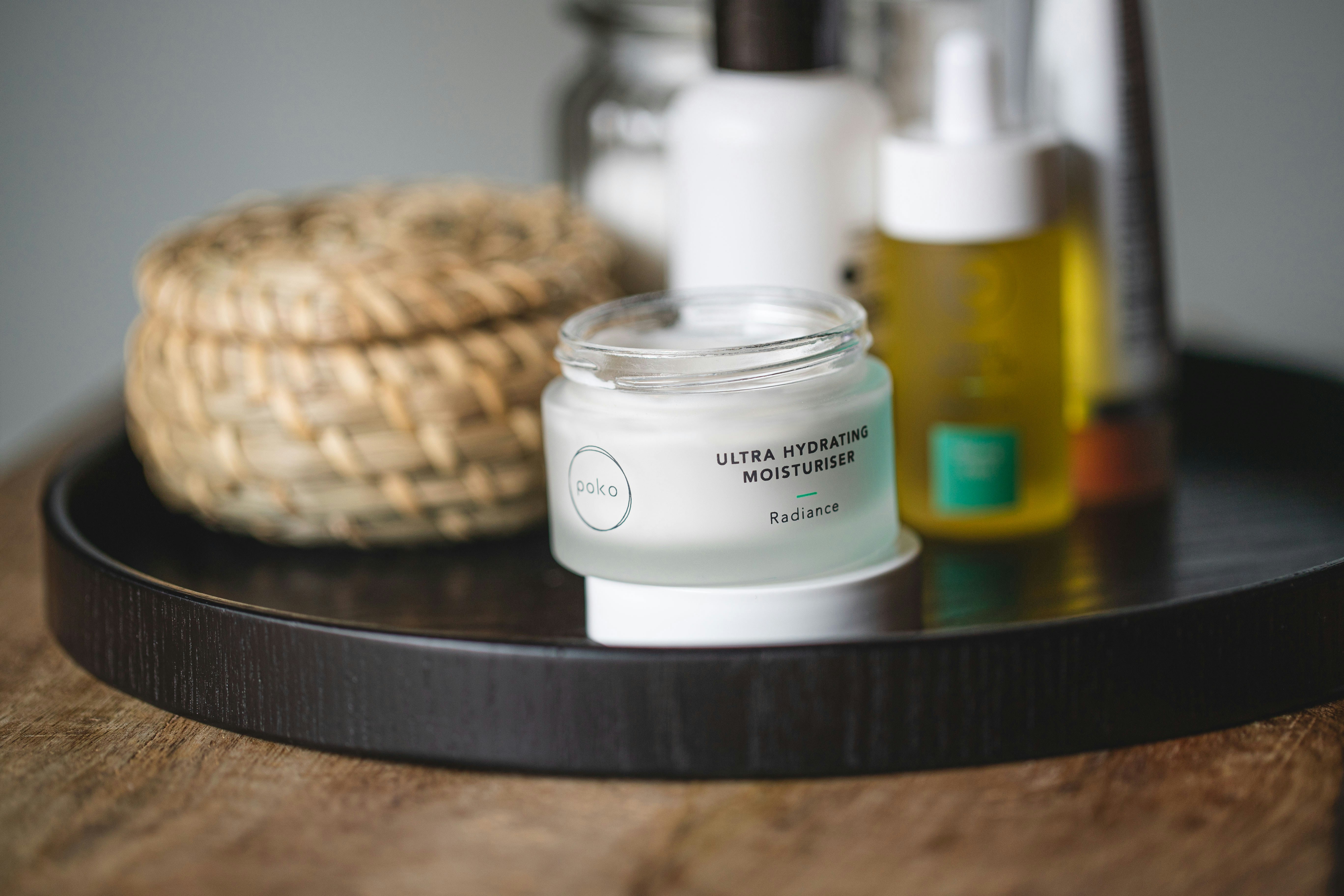 white and brown plastic bottle on black table, Skincare Products on Bathroom Shelf