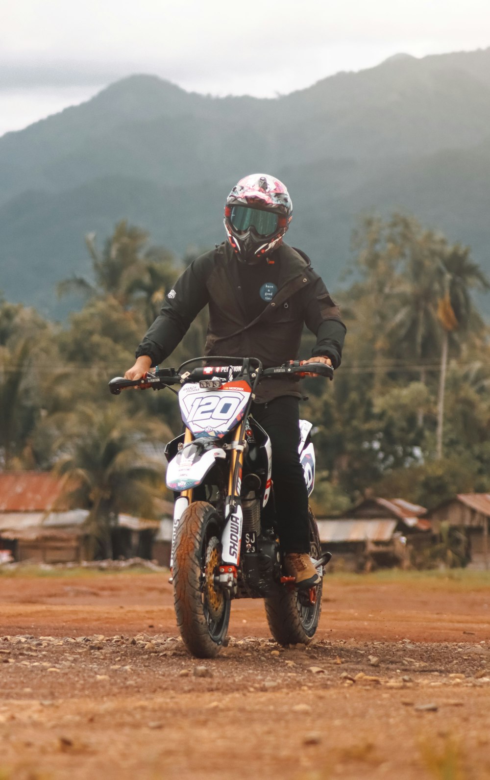 man in black and red motorcycle helmet riding on white and red dirt motorcycle during daytime