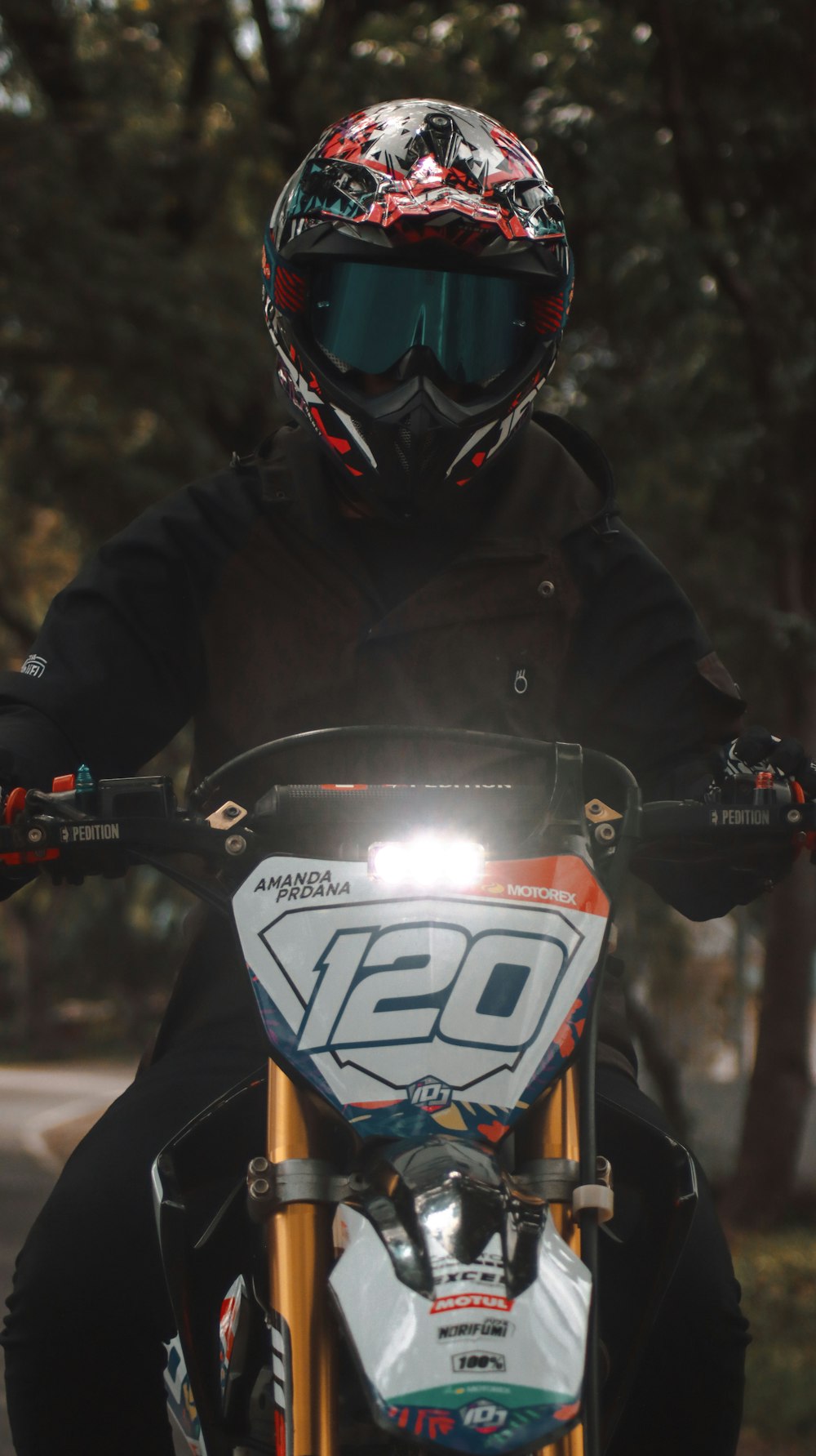 man in black jacket riding on black and orange motorcycle
