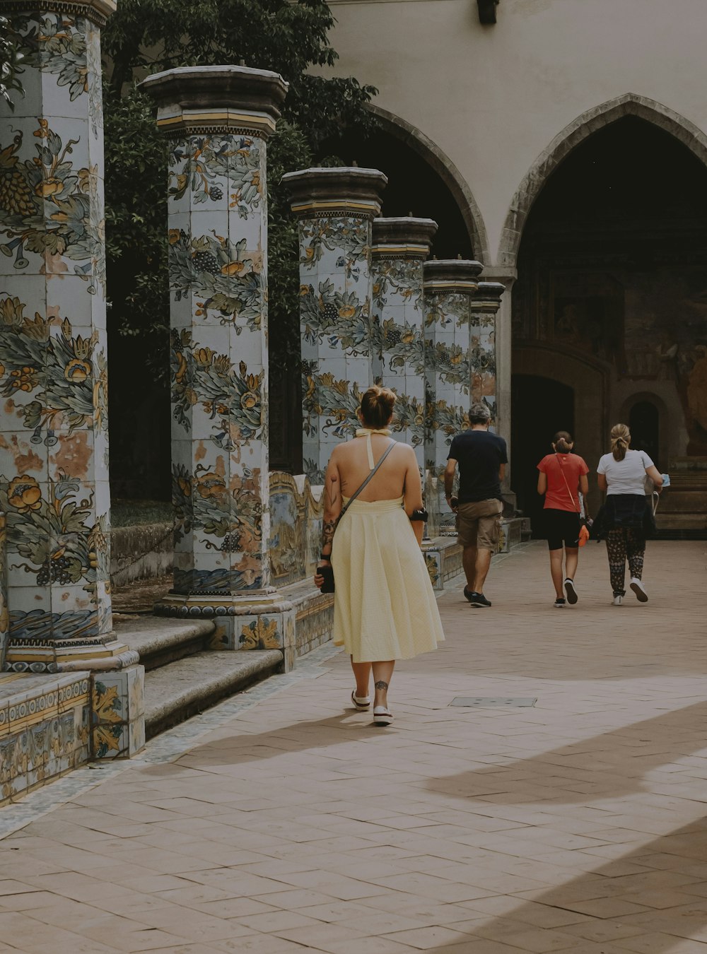 people walking on white and brown tiled floor