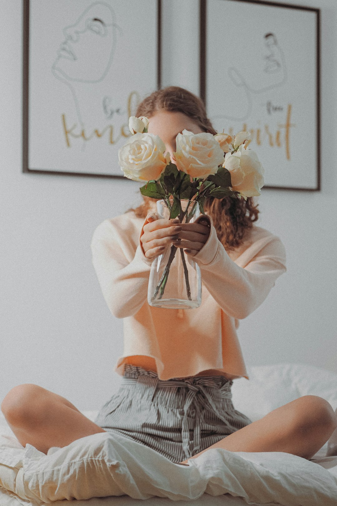 woman in white dress holding white rose bouquet