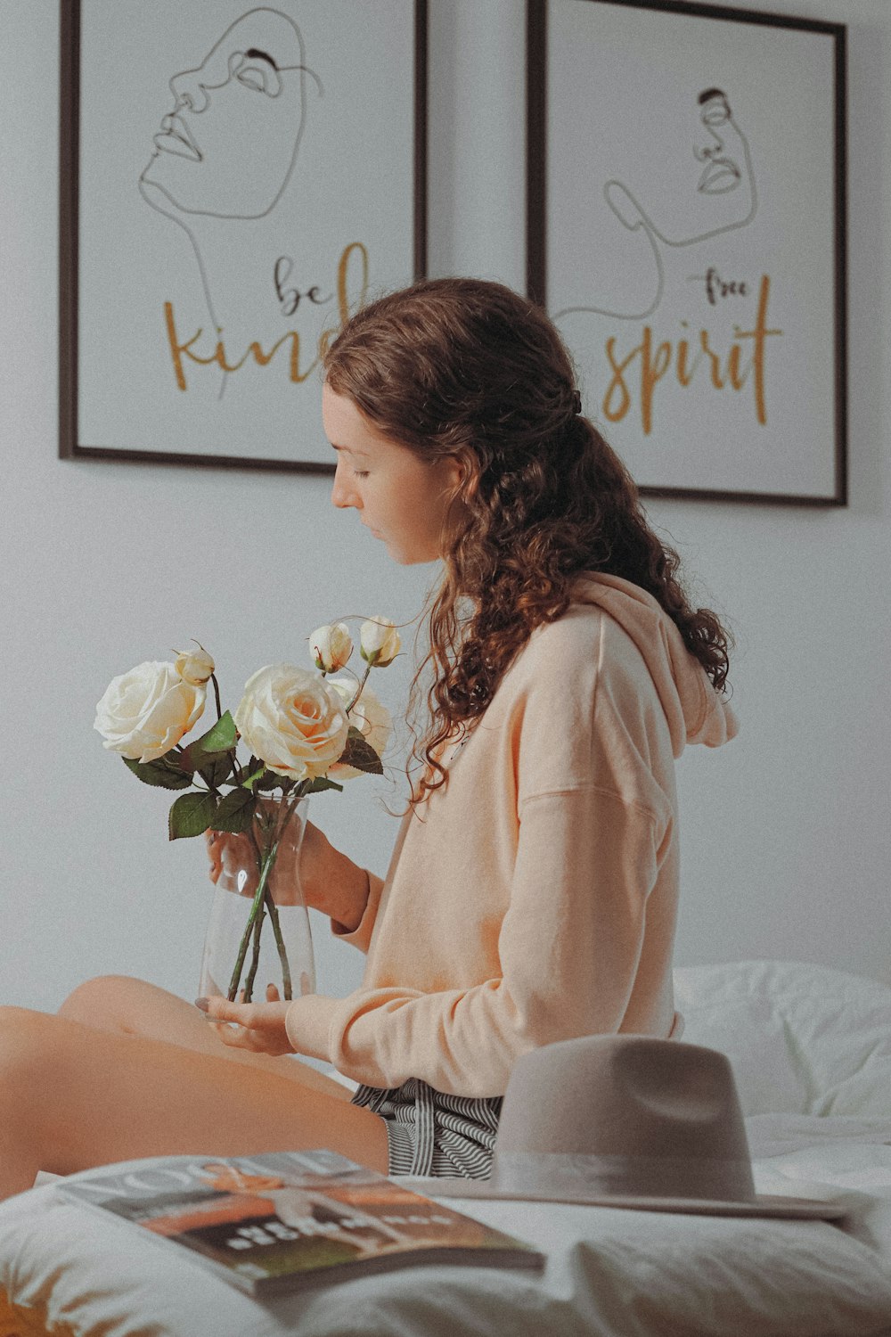 woman in white long sleeve shirt sitting on white bed