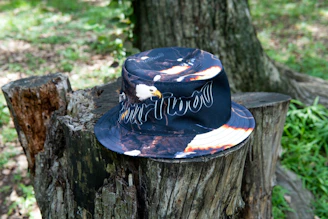 A classic trucker hat featuring Echoforge's emblem against a rustic wooden background.