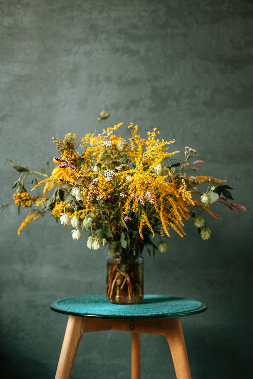 yellow and white flowers on brown ceramic vase