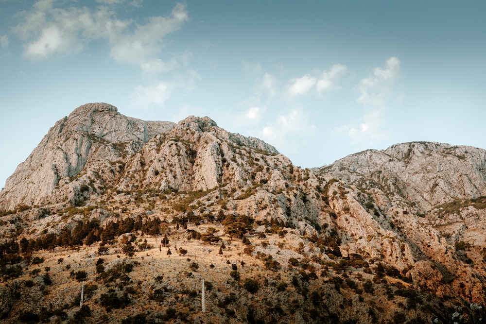 brown rocky mountain under blue sky during daytime