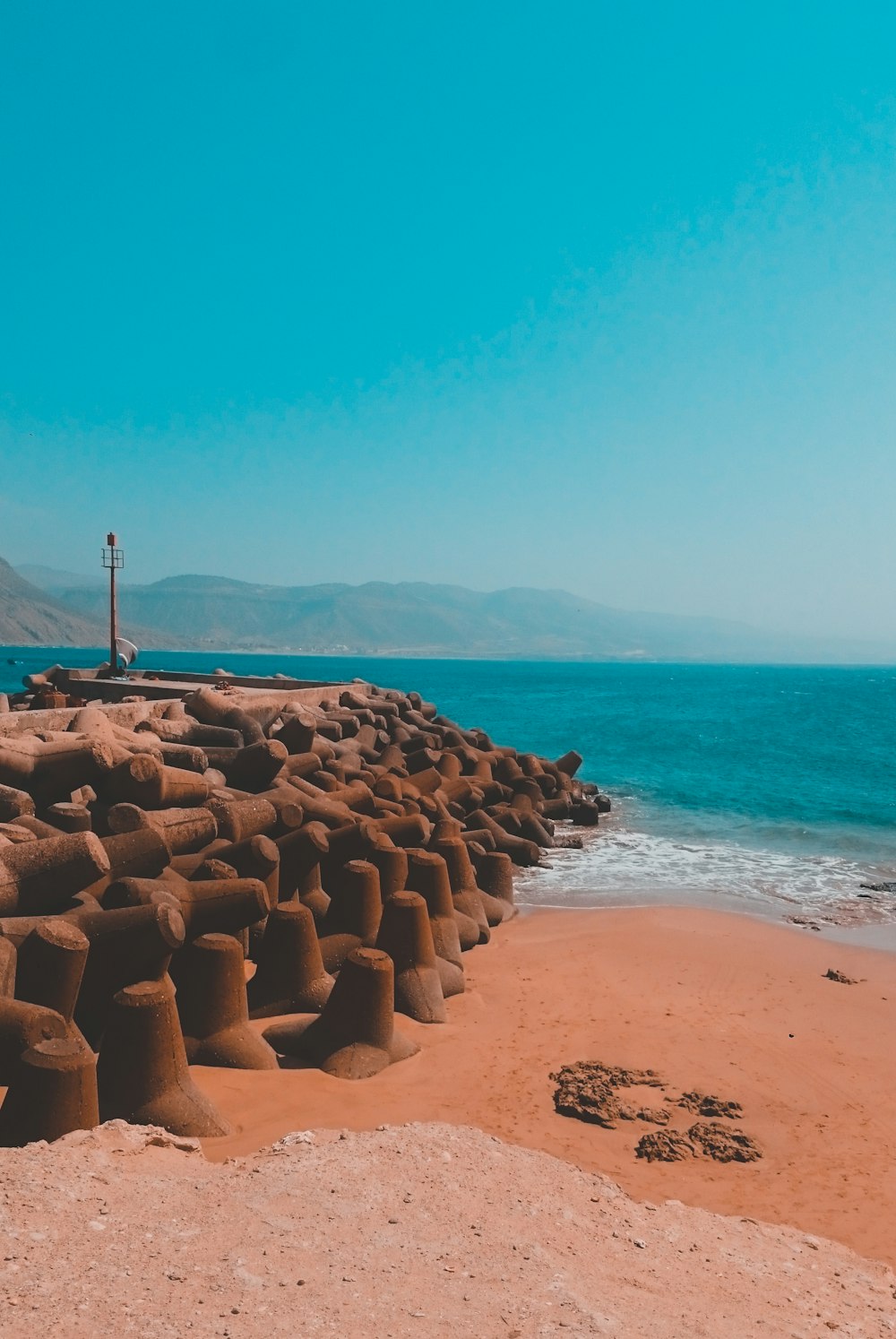 brown rocks on beach during daytime