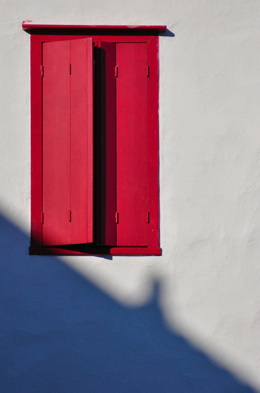 red wooden door on white wall