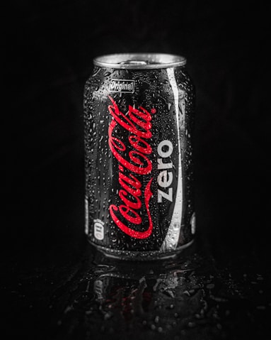 coca cola zero can on black surface