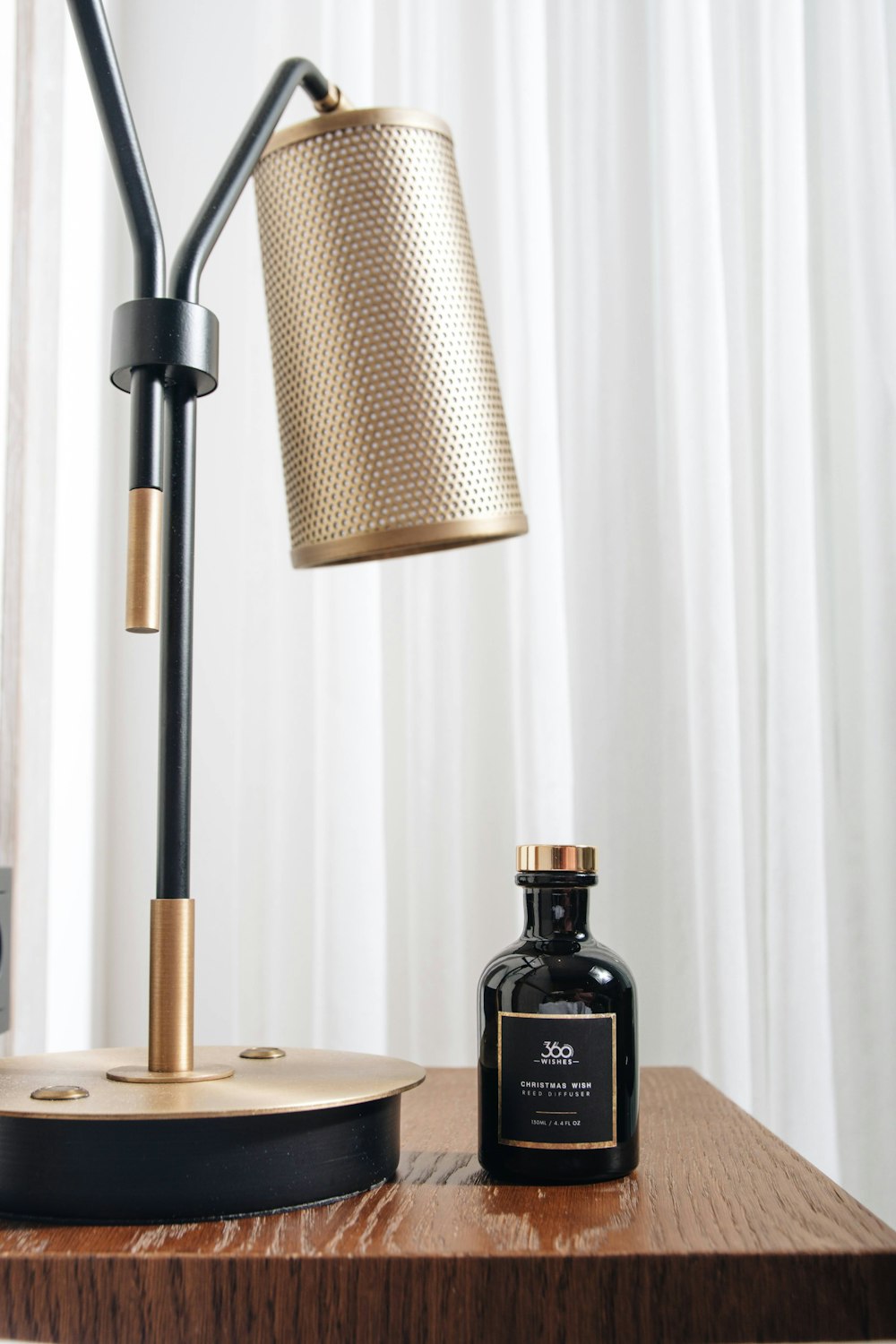 black glass bottle on brown wooden table