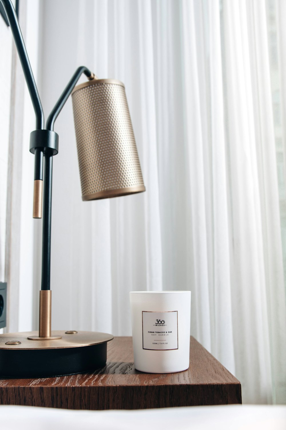 white and black table lamp on brown wooden table