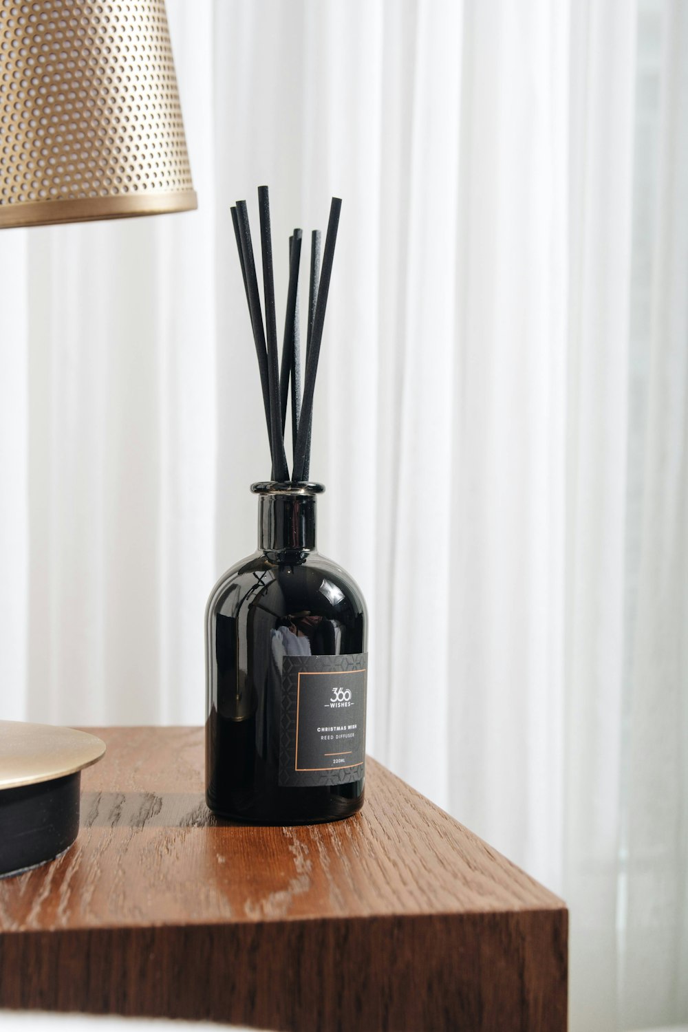 black glass bottle on brown wooden table