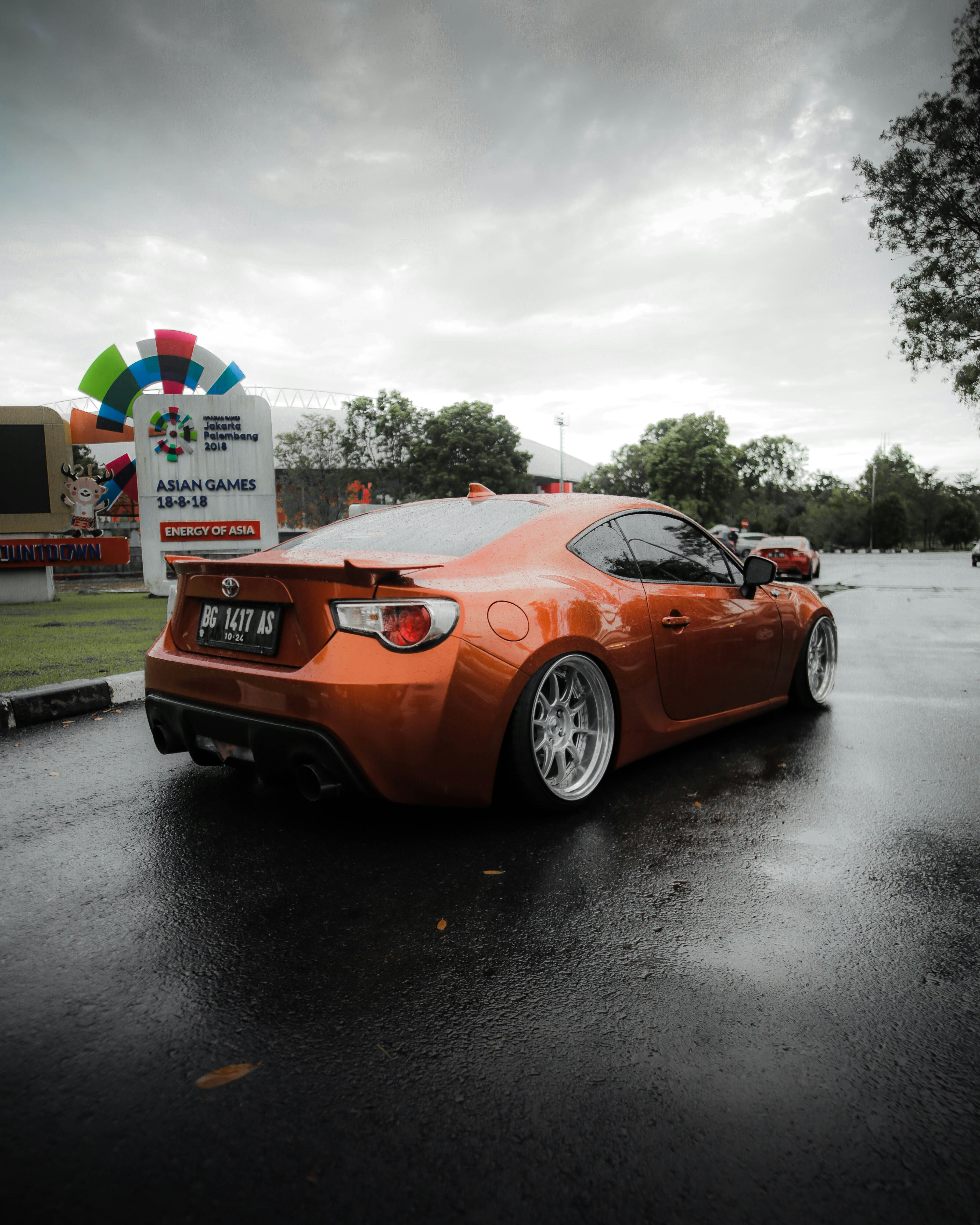 orange porsche 911 parked on road during daytime