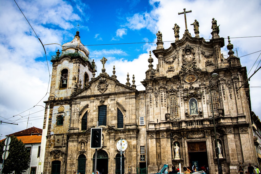 people walking near brown concrete church under blue sky during daytime