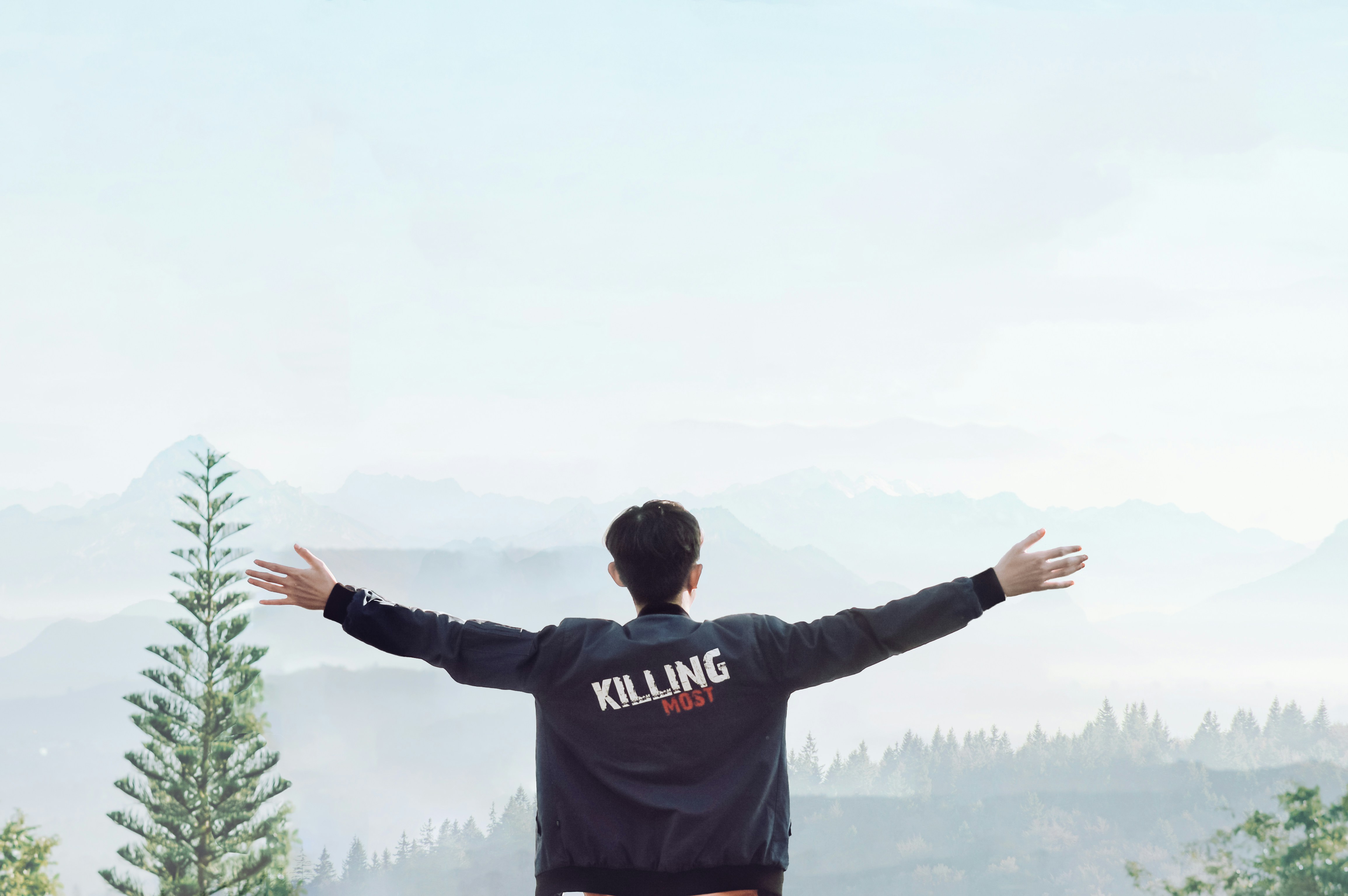 man in black hoodie raising his hands
