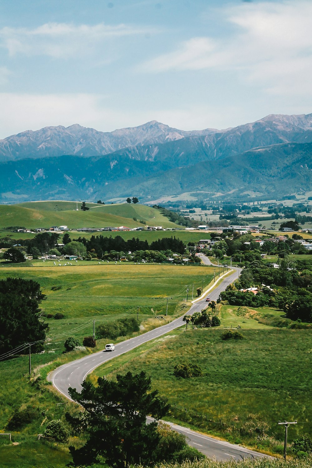 green grass field near mountain during daytime